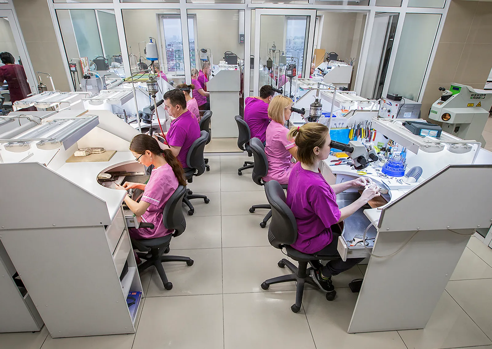 Jewelers at CJD Fine Jewelry sit in the workshop, meticulously crafting a custom jewelry piece. Is your custom jewelry made in-house or by partner workshops?