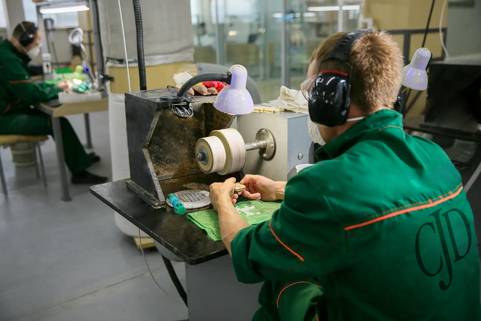 Talented artisans of CJD Fine Jewelry at work, crafting a piece. The jewelry polishing process.