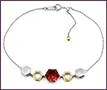 Custom honeycomb-design bracelet in platinum and 18K yellow gold with clear diamonds and a hexagon-cut ruby.