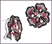 Custom 18K white gold floral earrings with black diamonds and rubies.