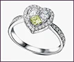 Custom engagement ring with round and pear-cut clear diamonds and a square yellow diamond.