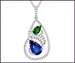 Large custom 14K white gold abstract pendant with pear sapphire, pear emerald, and clear diamonds.