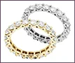 Two custom wedding rings in 18K white and yellow gold with clear diamonds.